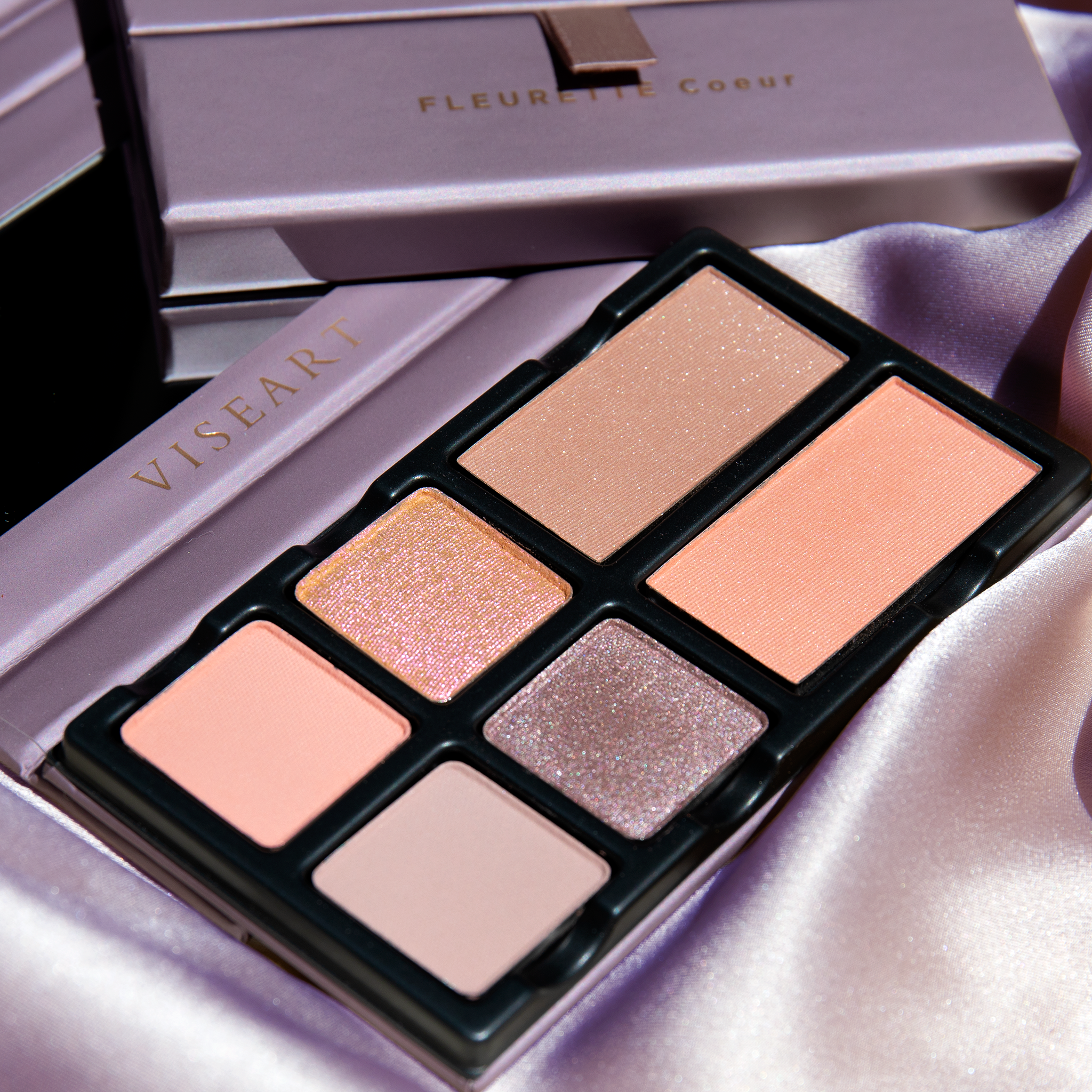Fleurette Coeur open palette with sheer lilac, soft pink, icy nude, and pale mauve tones in soft matte and pearlescent finishes.