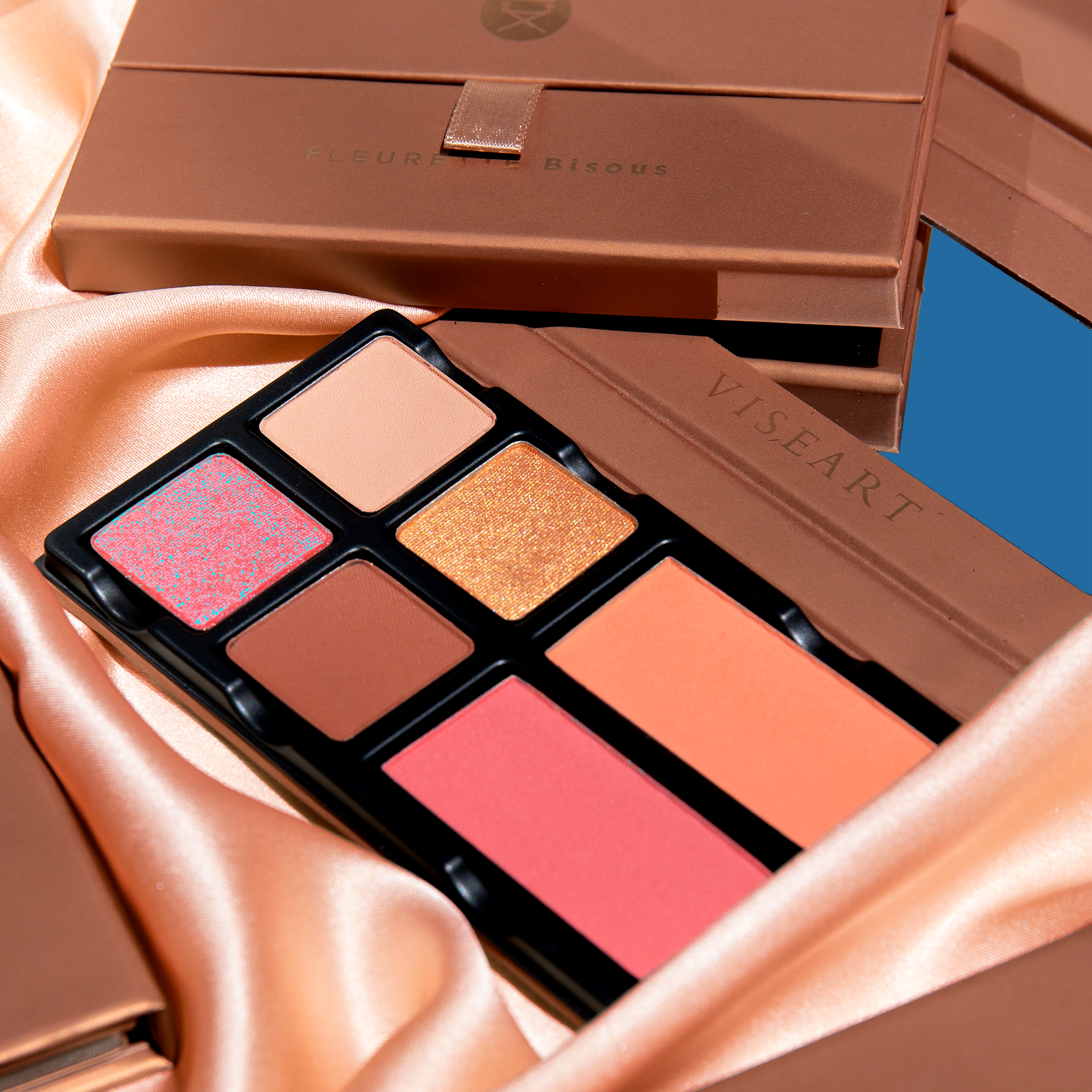 Fleurette Bisous open palette with rose pink, petal peach, and coral tones in matte and satin shimmer finishes for cheeks and eyes.