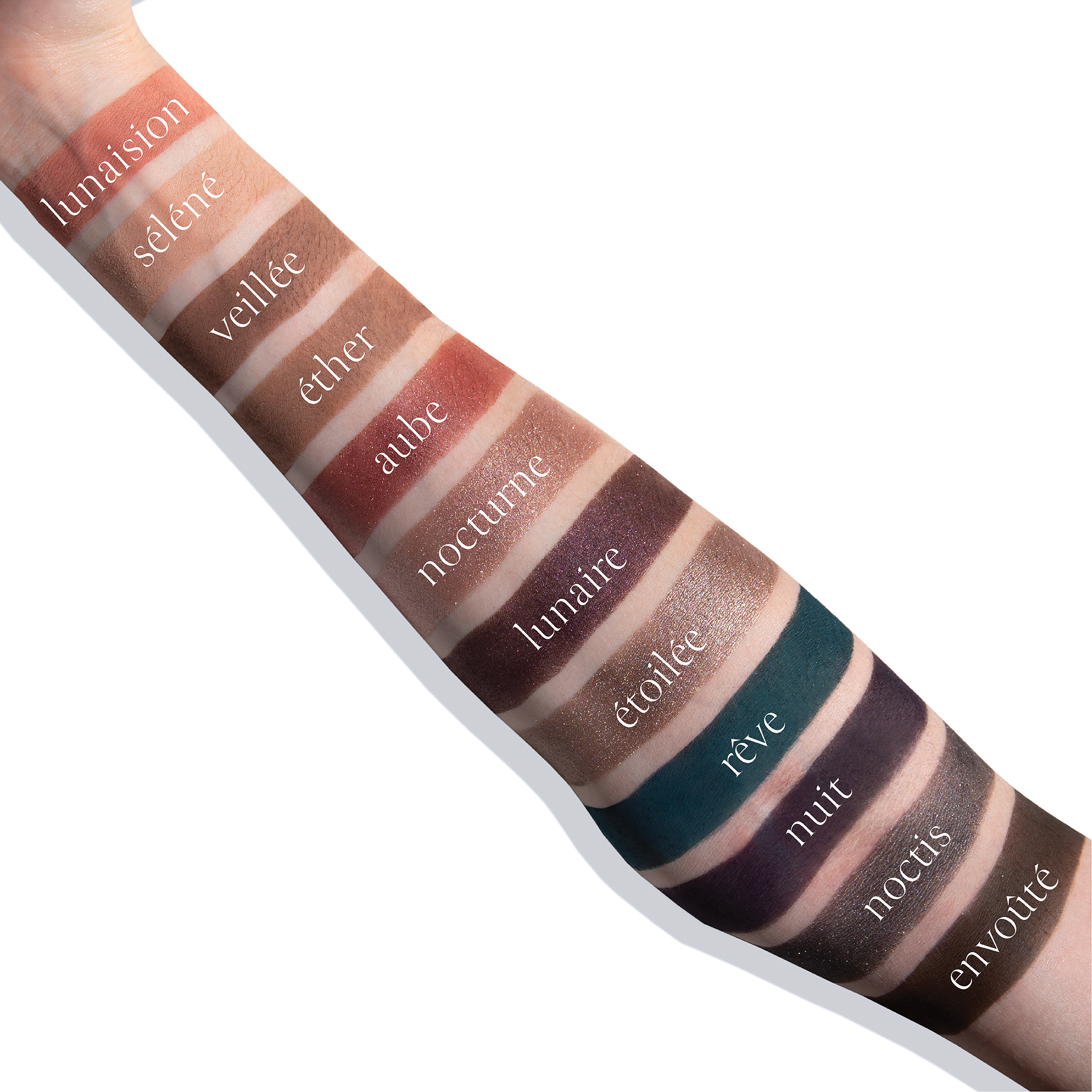 Swatches of PARIS NUIT ÉTENDU tones on fair skin, including nuit and aube hues for sculpting and blending.