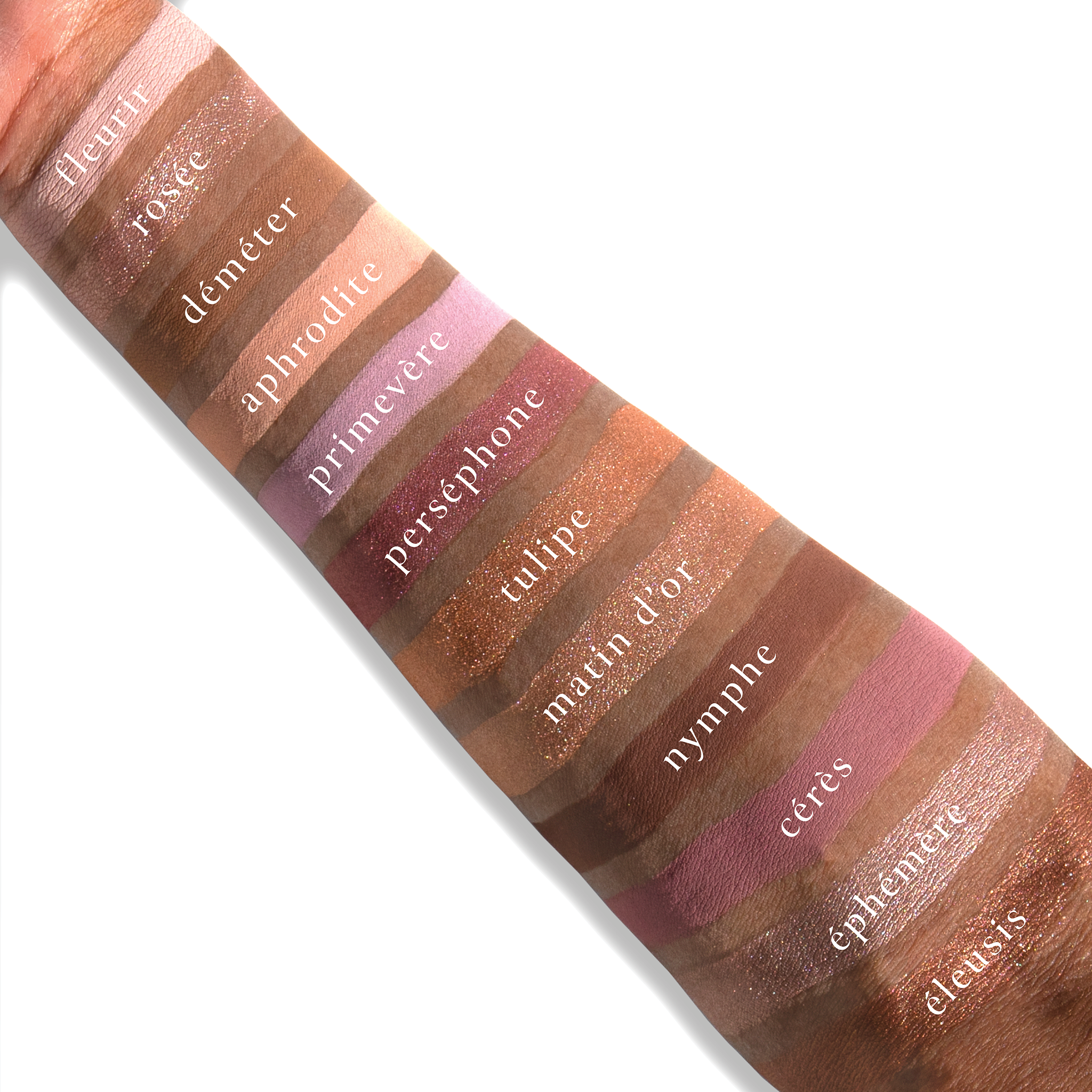 Swatches of Paris Rêveries on deep skin, showing pastel mauve, dusty taupe, and romantic peachy tones.