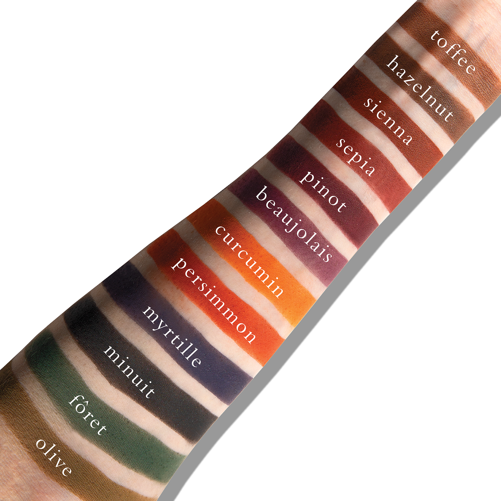 Swatches of deep mattes including navy and oxblood on fair skin, showing rich, dramatic colour payoff.