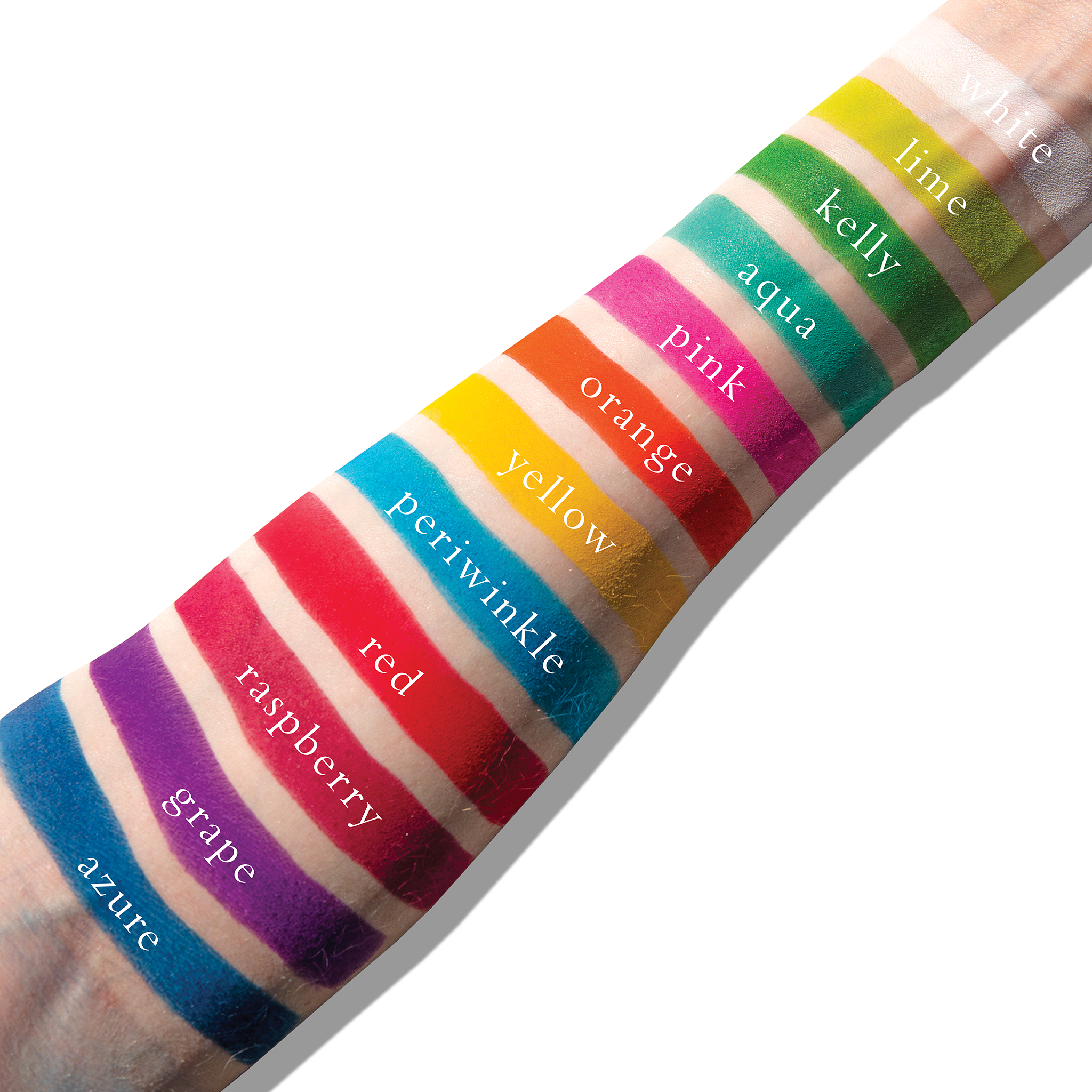 Swatches of bright matte shades on fair skin, from red and violet to yellow and green, showing bold payoff.