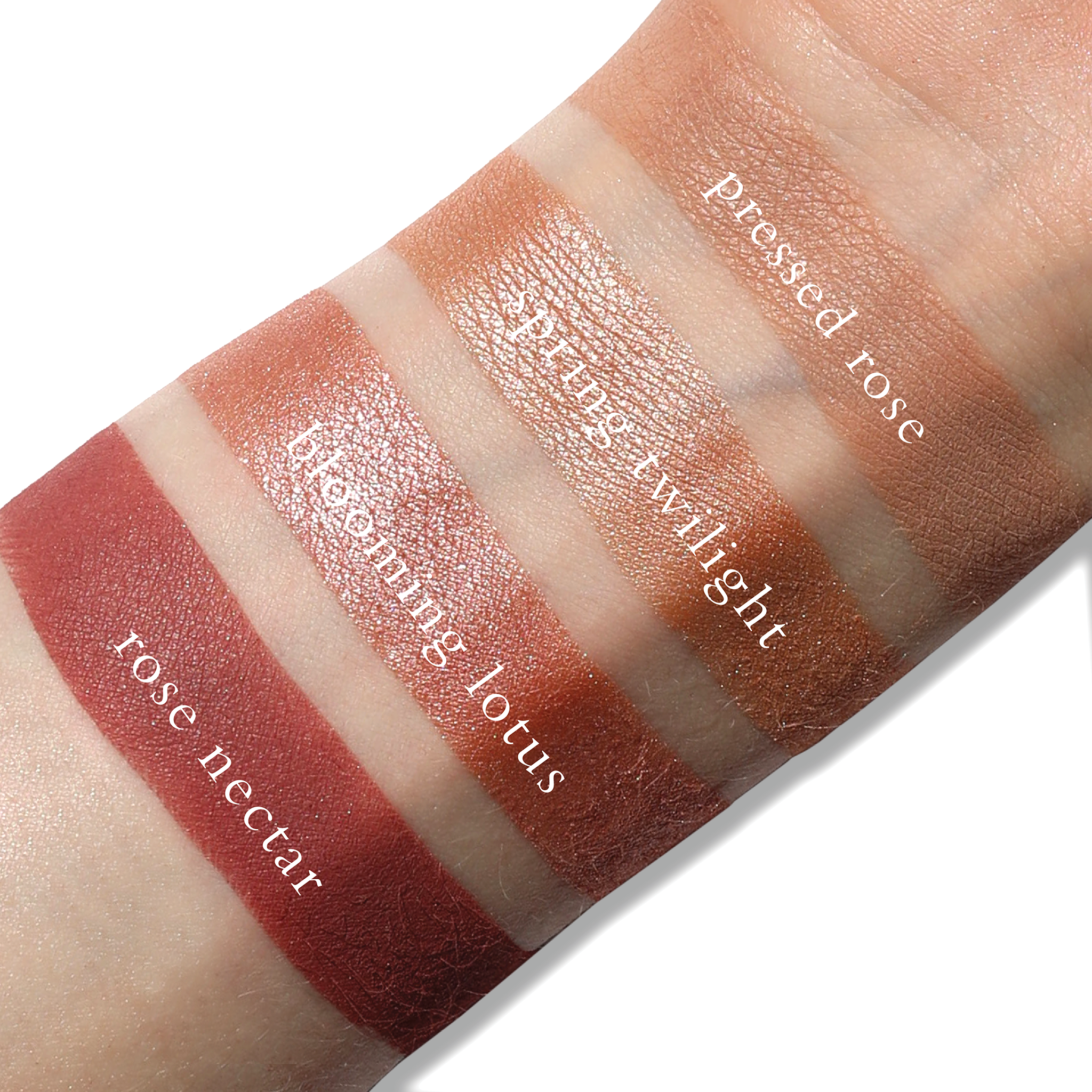Swatches of blush rose, coral shimmer, and warm pink matte from Rosea Lotus on fair skin tone.