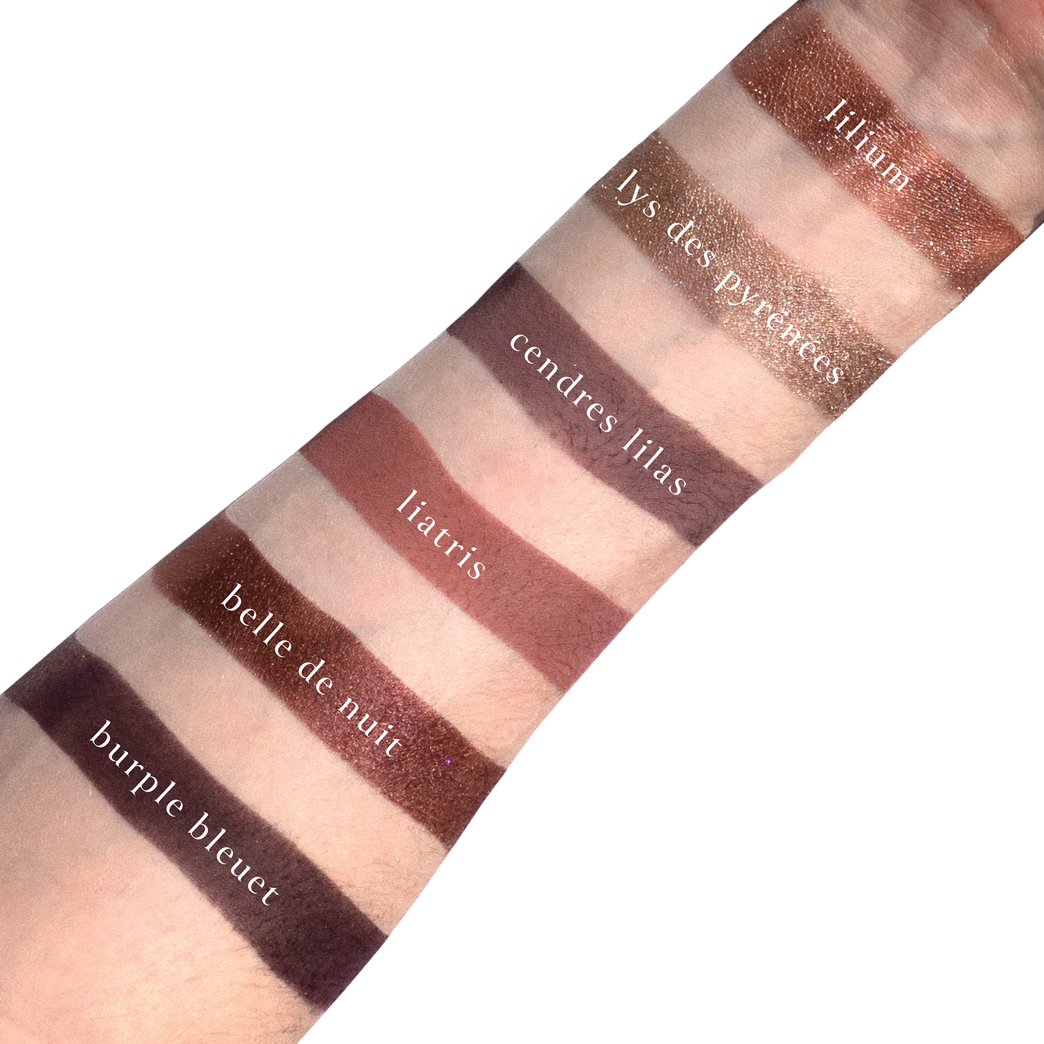 Swatches of Violette Vespertine on fair skin featuring plum matte, icy lilac shimmer, and mauve neutrals.