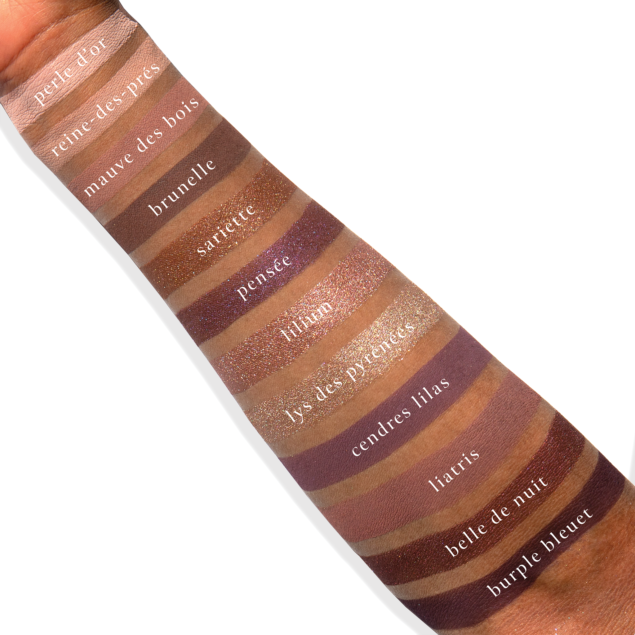 Swatches of Violette Vespertine on deep skin with violet duochrome, taupe matte, and cool shimmer tones.