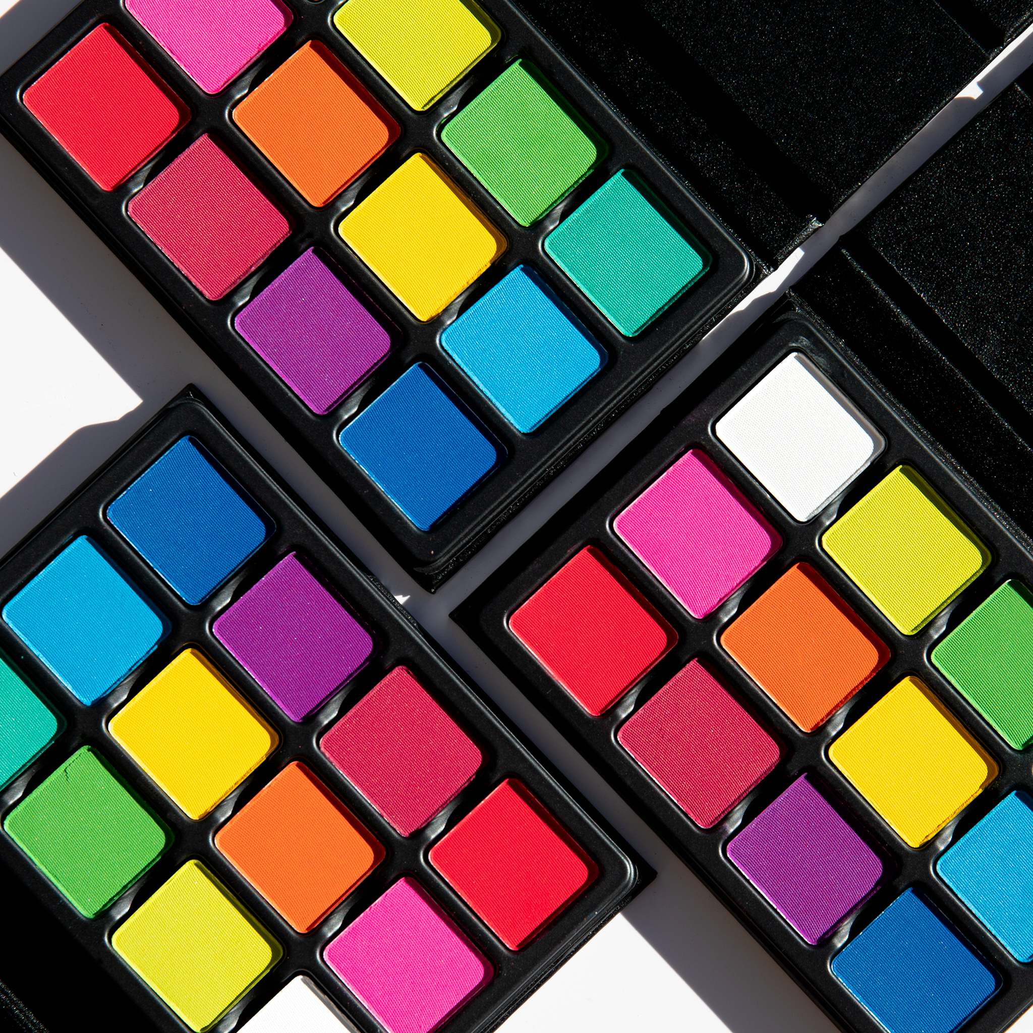 Open palette of 12 vivid matte brights including red, cobalt, yellow, and green, designed for editorial and artistic looks.
