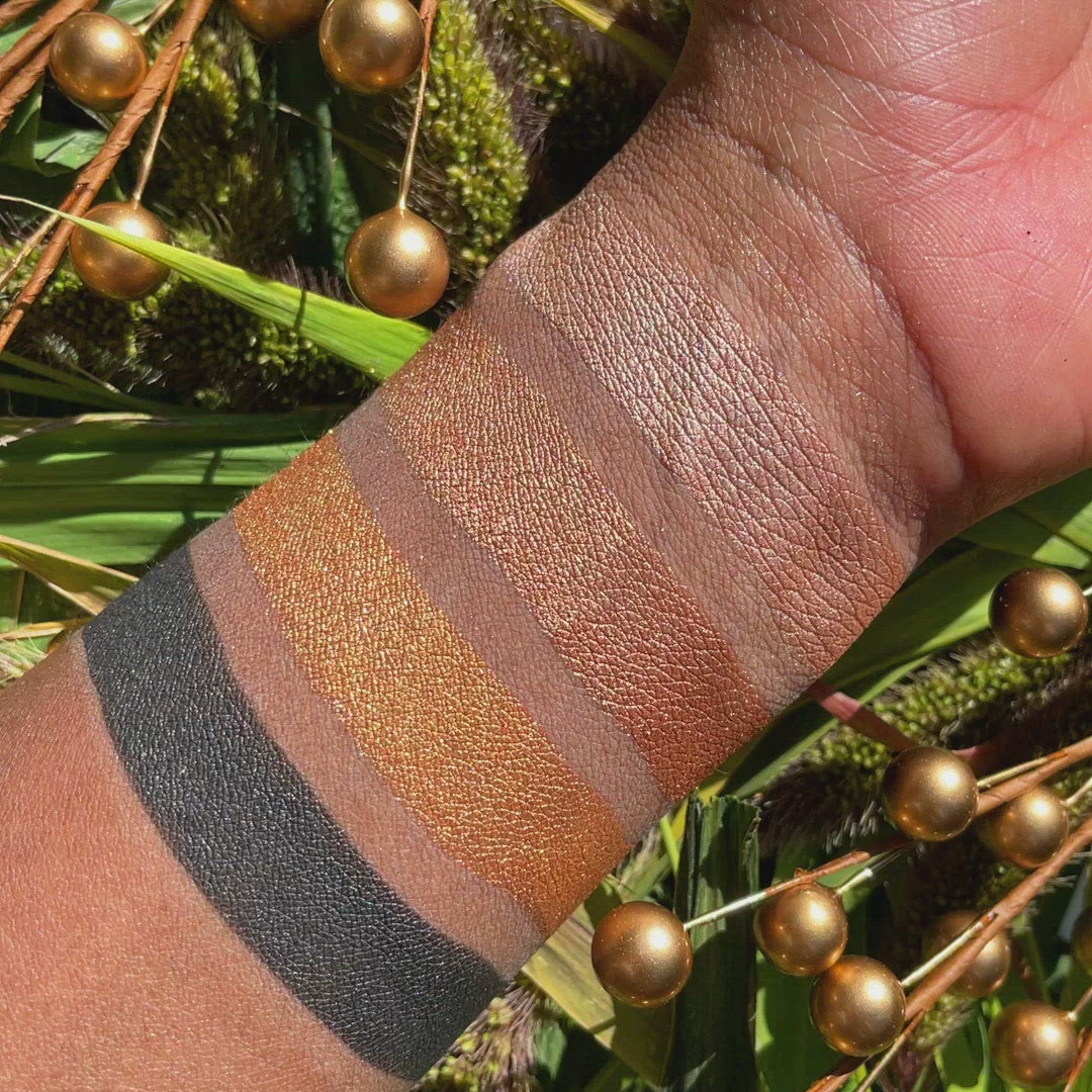 Swatches of Petits Fours Bullion on deep skin, with bold gold, light metallic shimmer, and deep matte black.