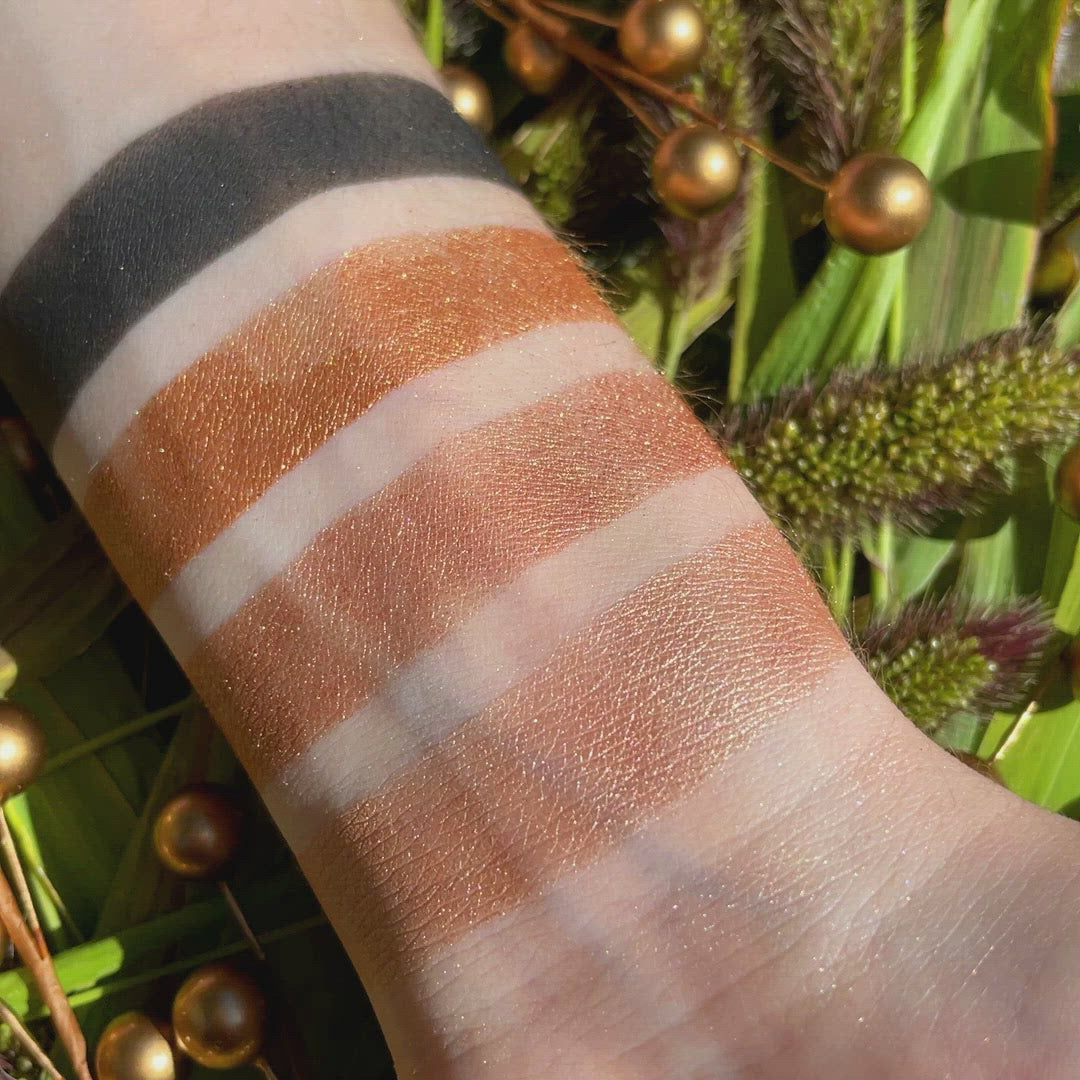 Swatches of Petits Fours Bullion on fair skin, with bold gold, light metallic shimmer, and deep matte black.