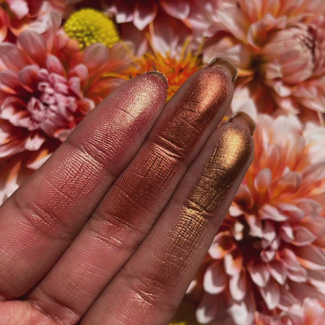 Swatches on fair skin showing warm espresso, peach, and bronze shades with soft-to-sultry payoff