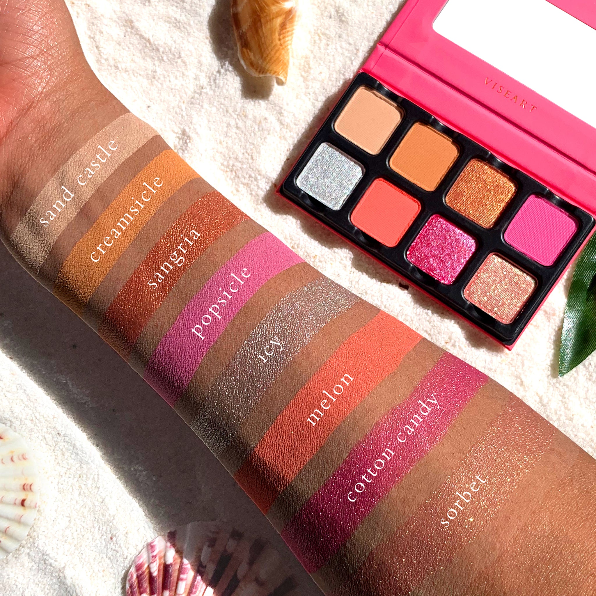 Pastel pink, peach, and shimmer lilac shades from Chou Chou on deep skin tone.