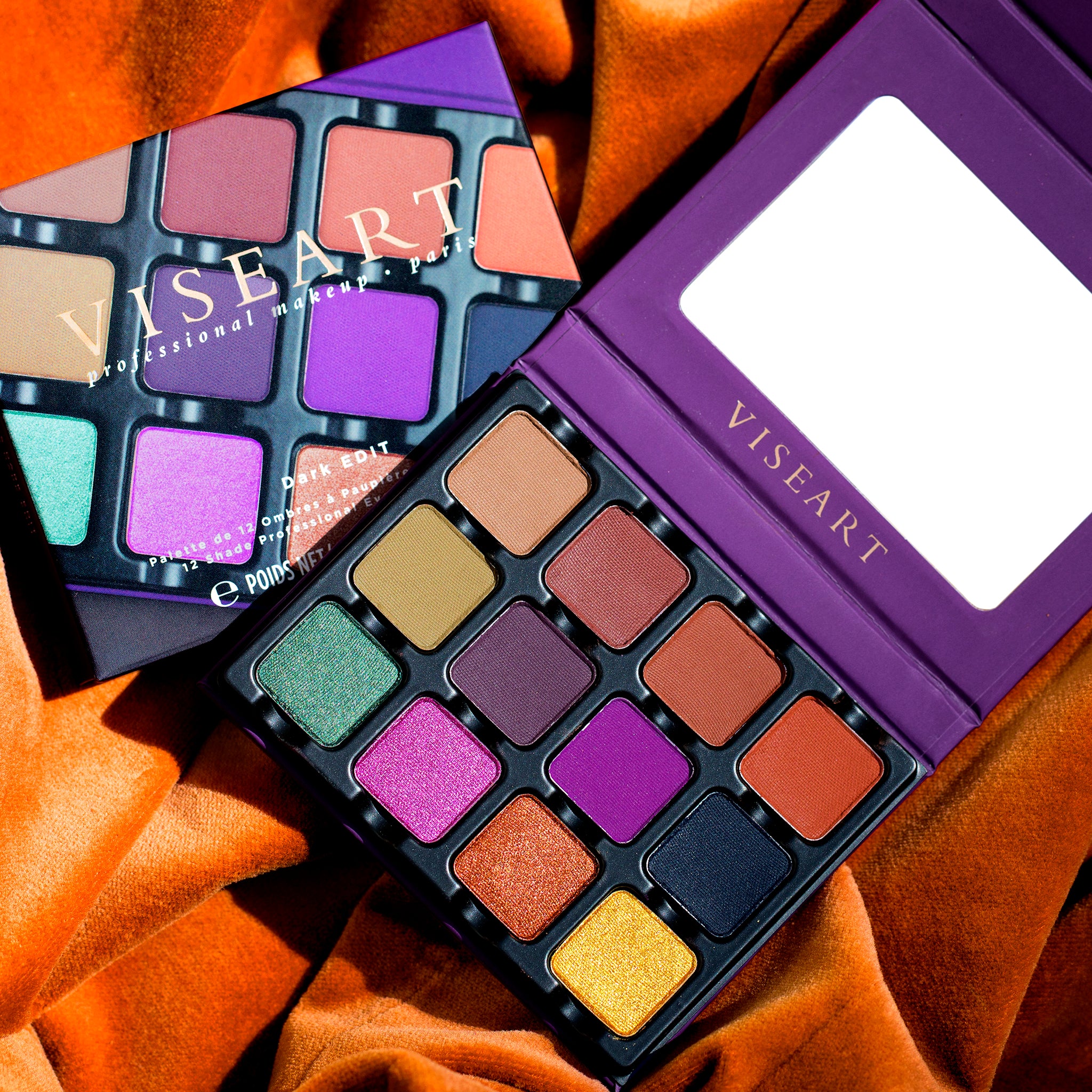 Open Dark Edit eyeshadow palette showing emerald, copper, plum, and gold shades in matte and shimmer finishes.