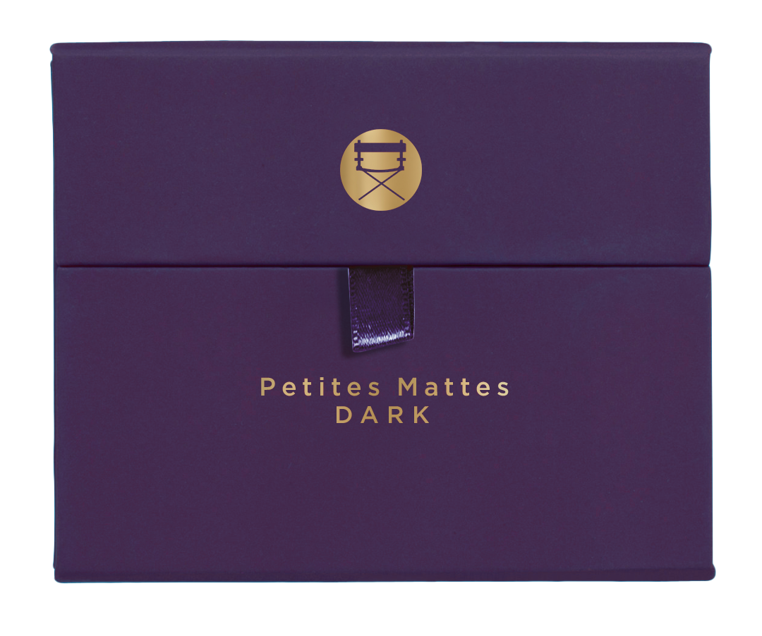 Closed palette displaying deep matte hues like navy, plum, and bark brown for bold smoky or editorial looks.