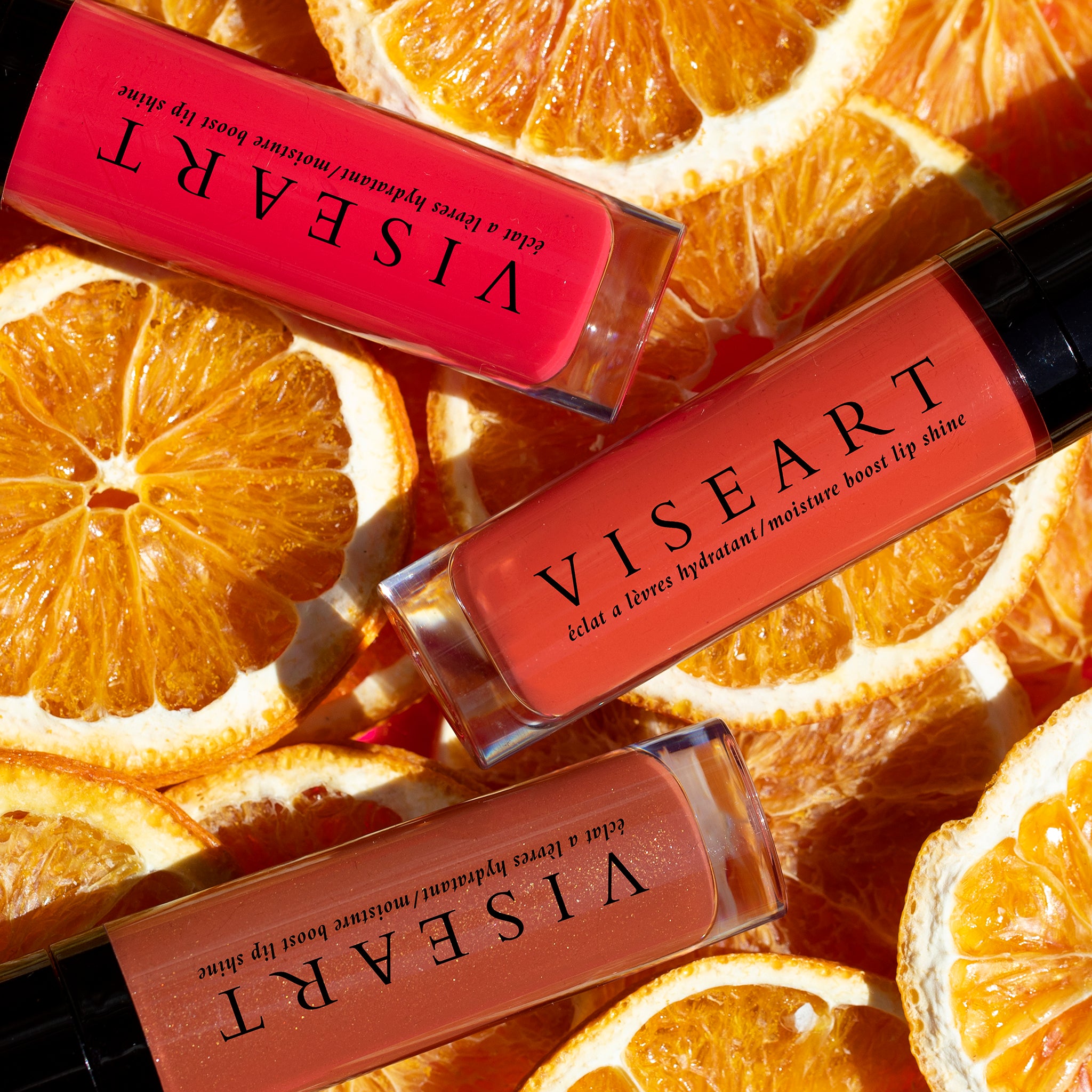Viseart Moisture Boost Oil Lip Shine in ‘Scala’ – a clear tube with black cap, displaying a deep berry-tinted lip oil.