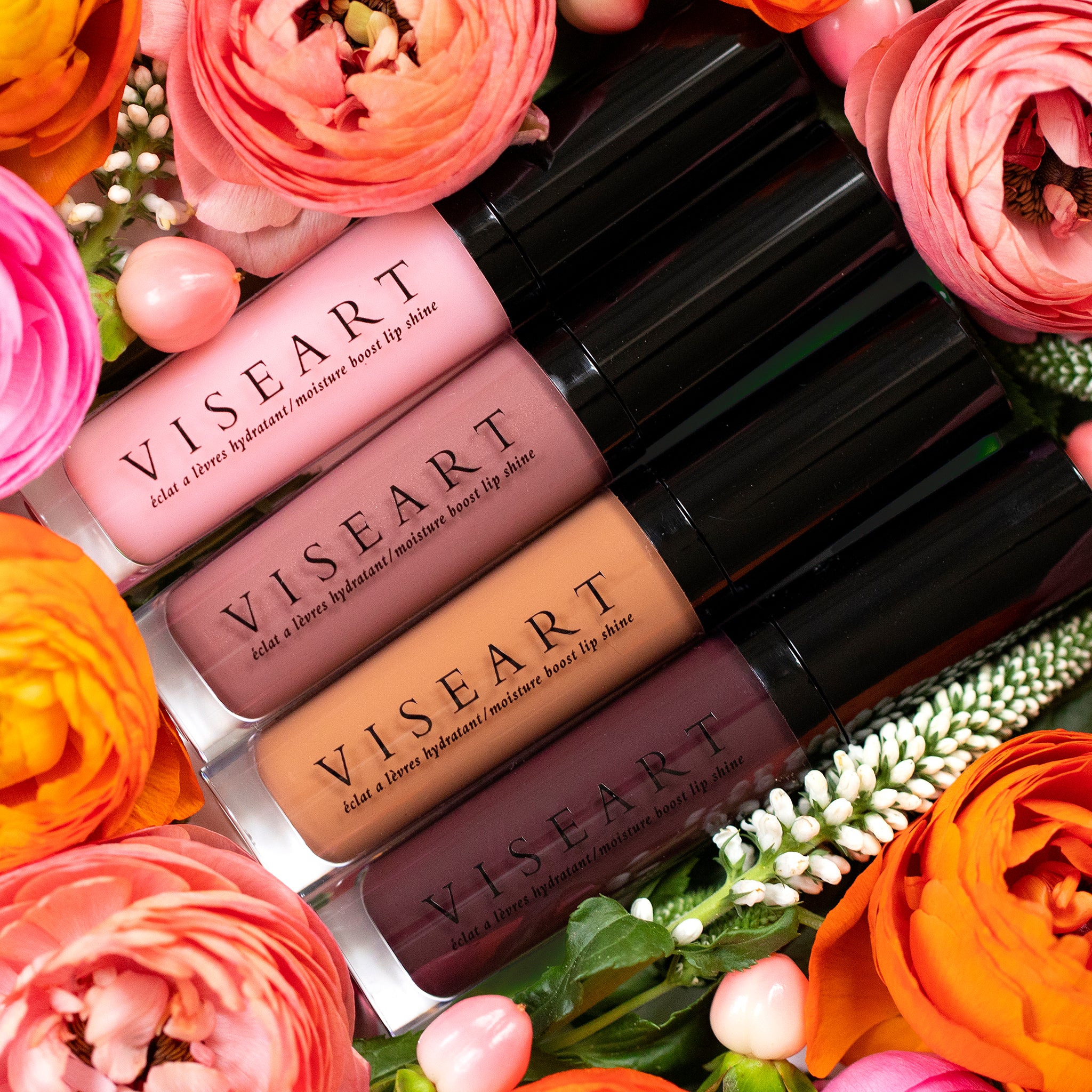 Viseart Moisture Boost Oil Lip Shine in ‘Cerise’ – a clear tube with black cap, holding a cherry red-tinted lip oil.