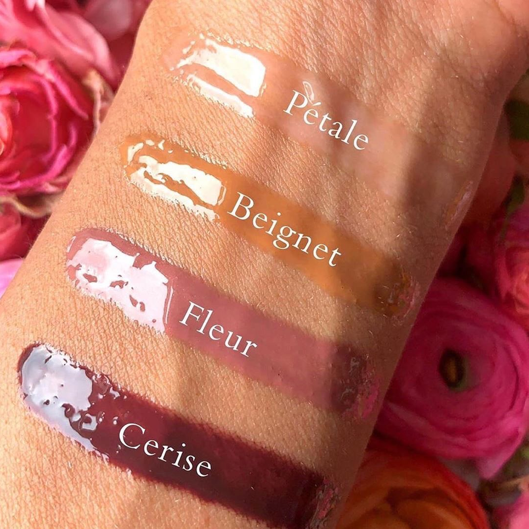 Viseart Moisture Boost Oil Lip Shine in ‘Cerise’ – a clear tube with black cap, holding a cherry red-tinted lip oil shown on skin