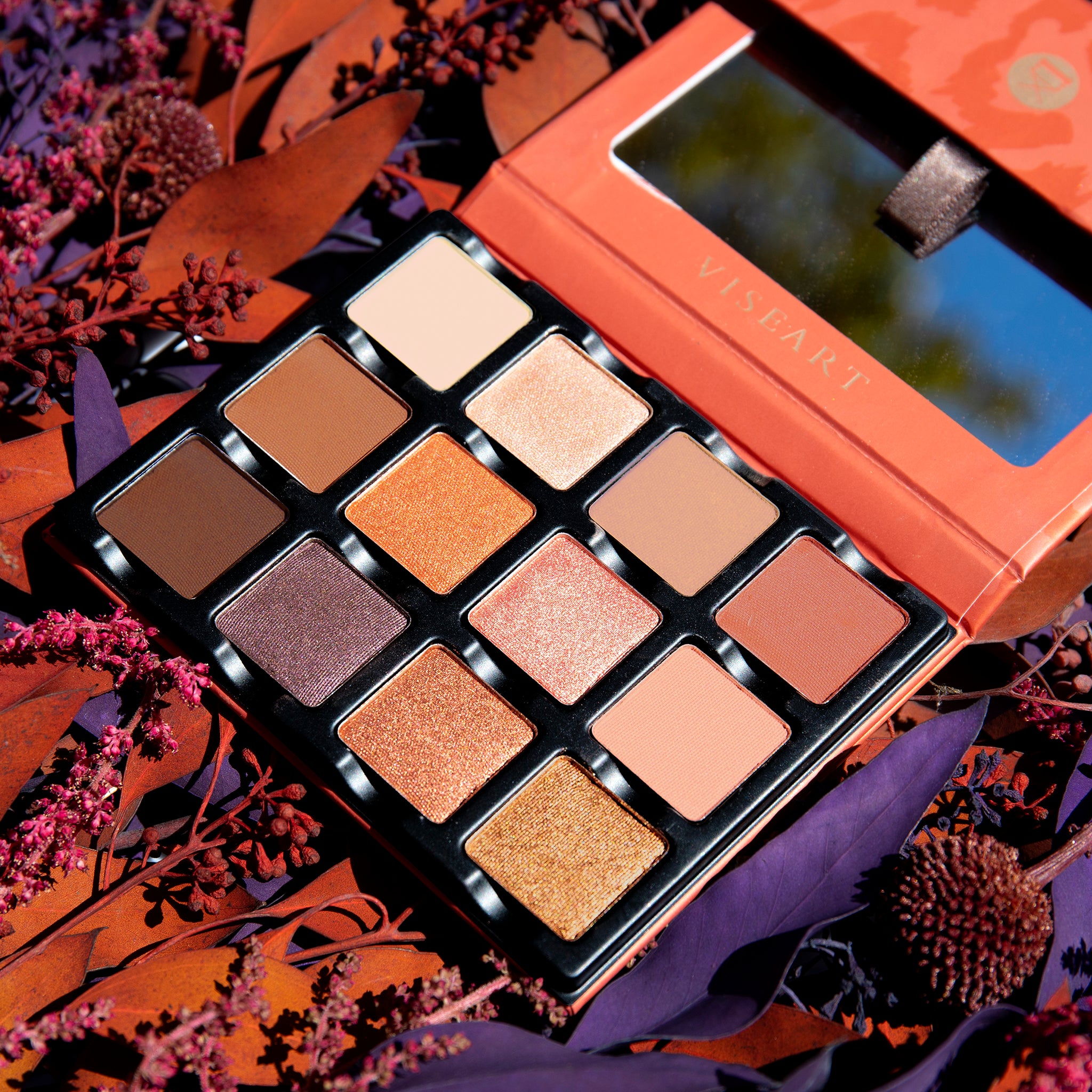 Open palette of rich warm neutrals including espresso, bronze, and terracotta with matte, satin, and shimmer finishes.