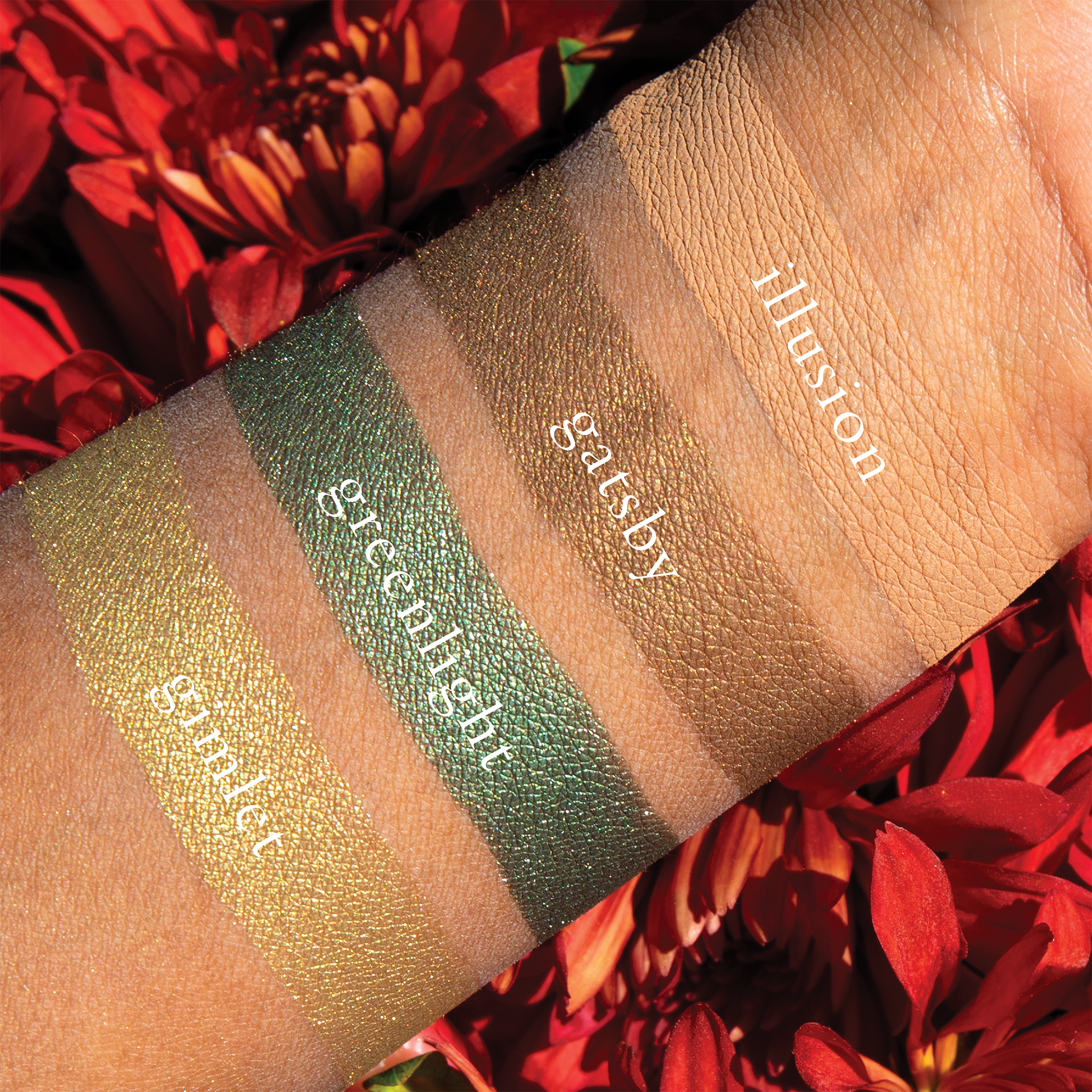 Swatches of eyeshadow powders from the Petits Fours - Peridot palette on deep skin, showcasing elegant green and earthy brown tones to add a luxe look to any eye.
