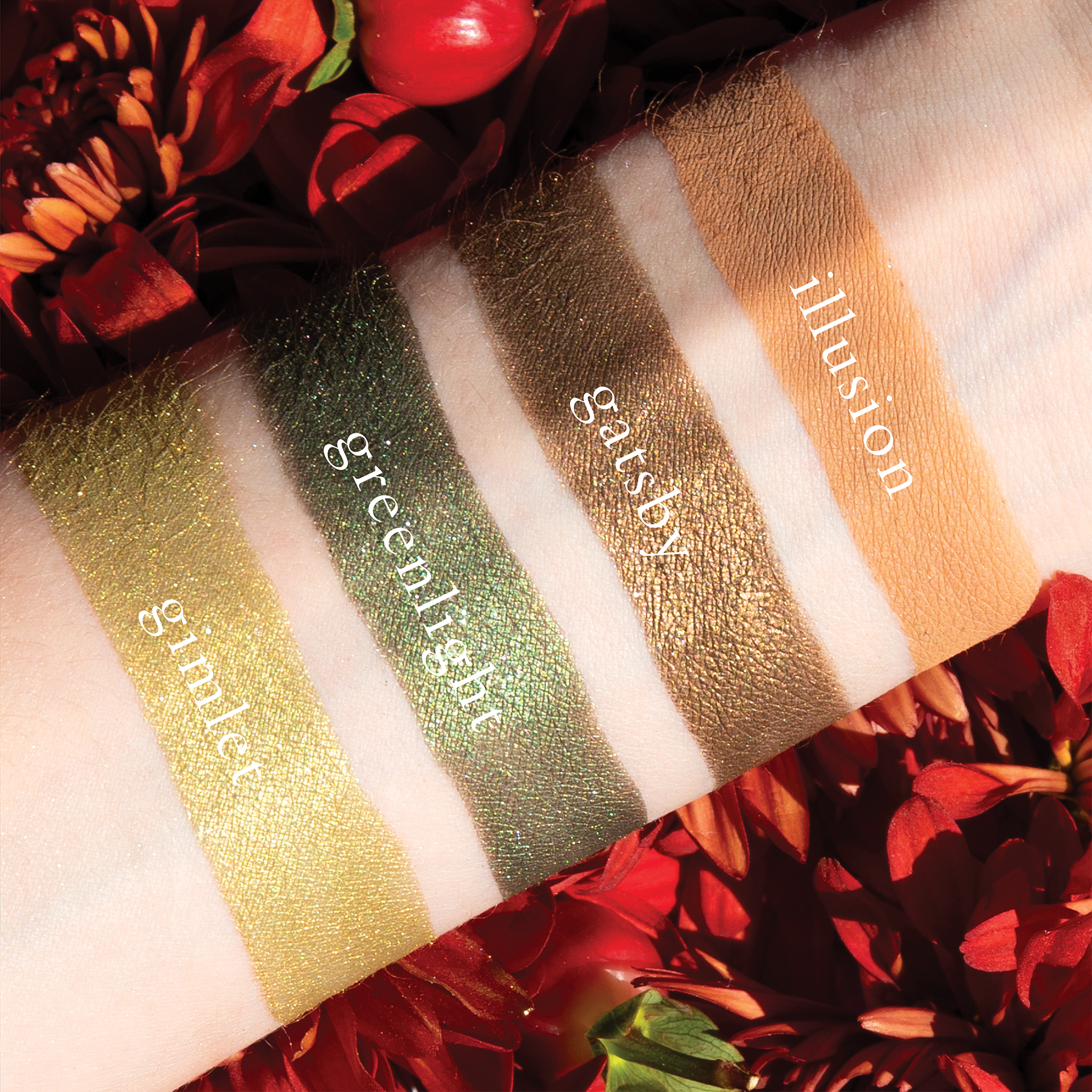 Swatches of eyeshadow powders from the Petits Fours - Peridot palette on fair skin, showcasing elegant green and earthy brown tones to add a luxe look to any eye.
