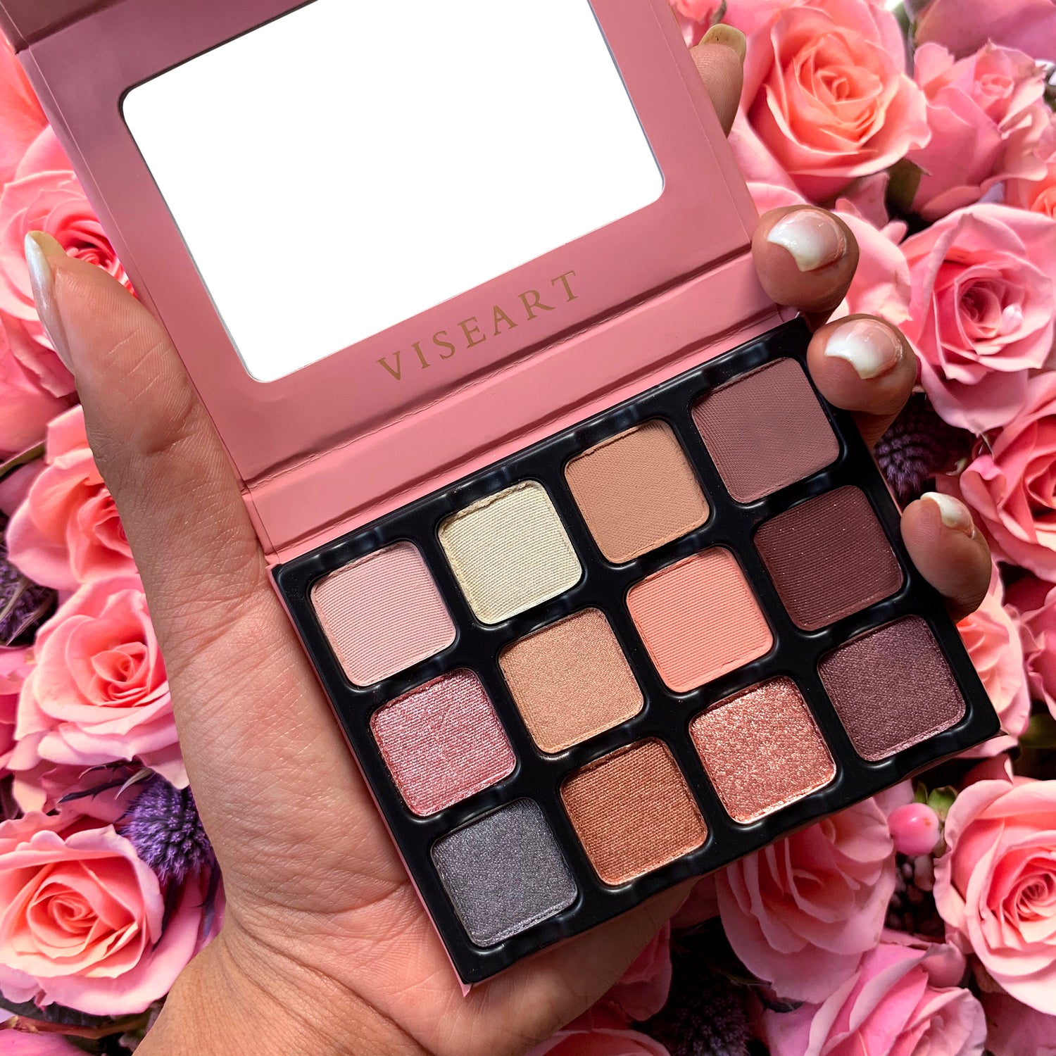 Open Paris Edit 12-pan palette on a white background showcasing swatches of dusty pink, mauve, camel brown, and smoky purple in matte, metallic, and satin finishes.