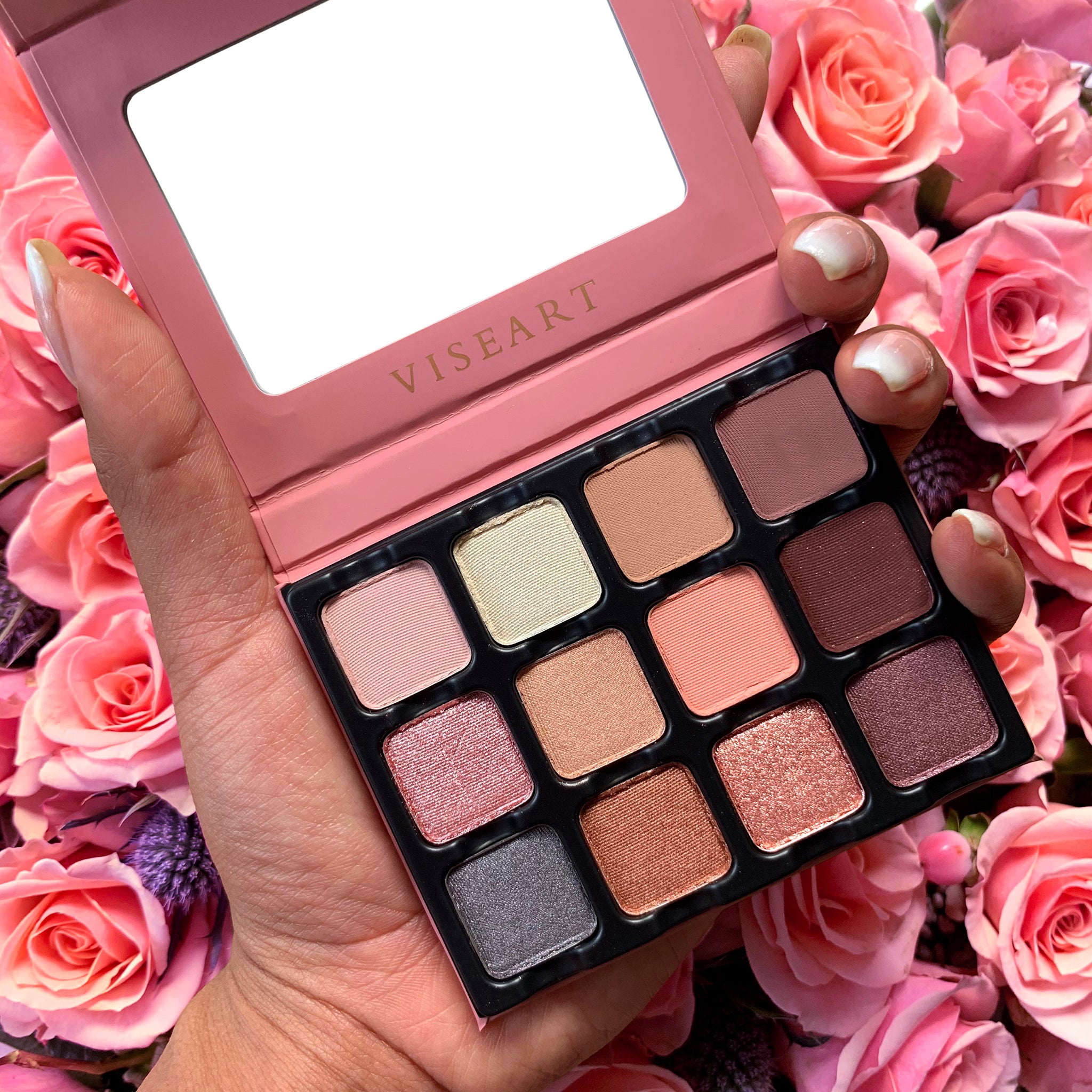 Open Paris Edit 12-pan palette on a white background showcasing swatches of dusty pink, mauve, camel brown, and smoky purple in matte, metallic, and satin finishes.