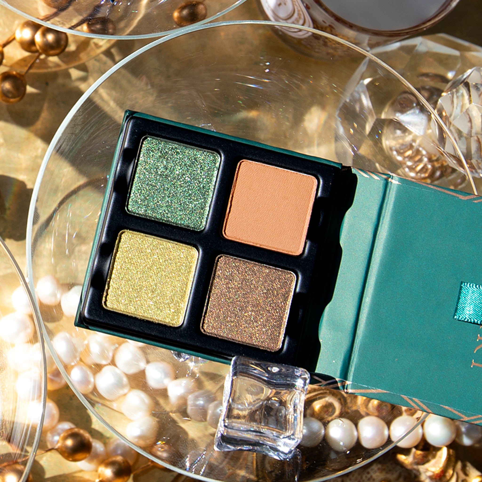 Open Petits Fours - Peridot 4-pan palette showcasing pressed powders in metallic forest and bright green, metallic khaki, and matte buff-brown.