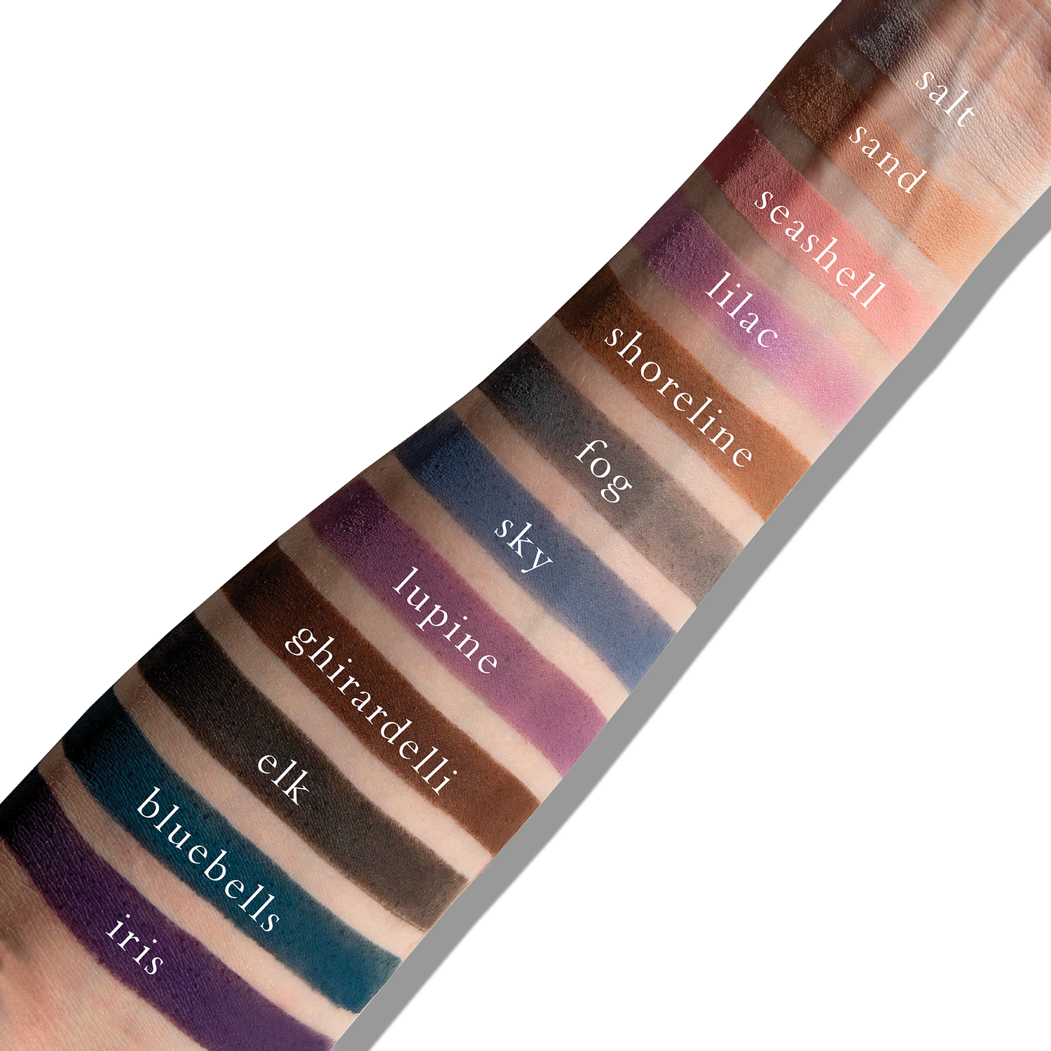 Swatches of cool mauve and taupe mattes on fair skin, ideal for romantic, defined looks.