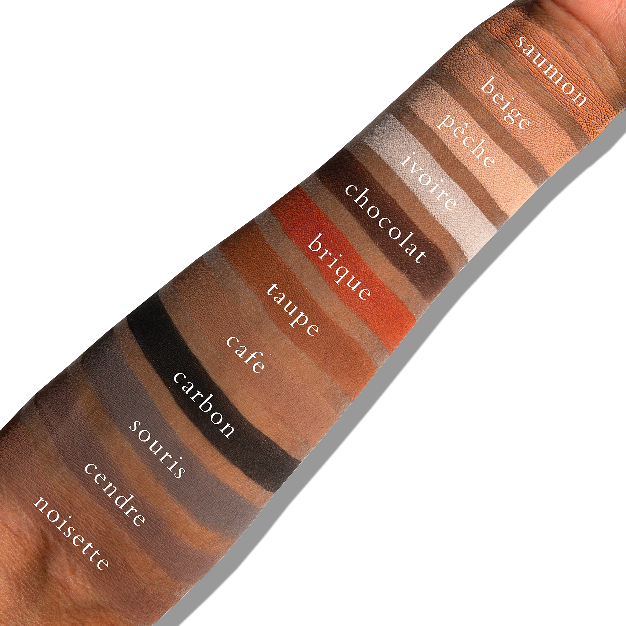 Swatches of matte neutrals on deep skin, showing taupe and brown tones suitable for everyday contour.