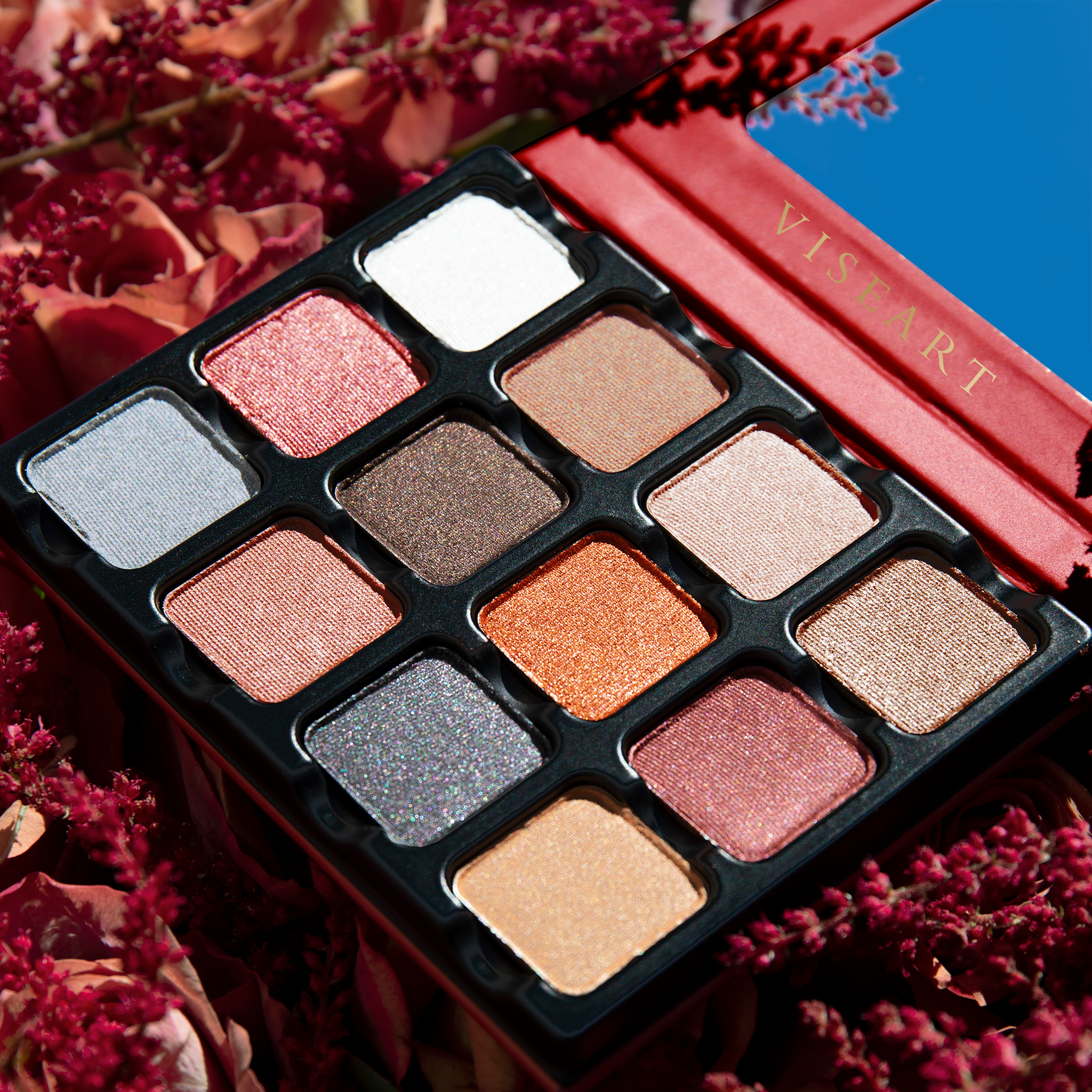 Open Petites Shimmers Sultry Muse 12-pan palette displaying 12 pressed powders in a range of warm brown, rose, copper, and silver shades in satin, metallic, and shimmer finishes.