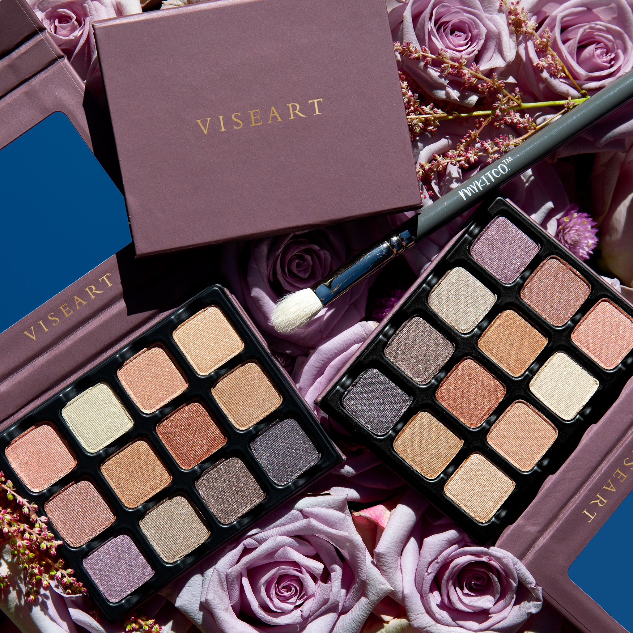 Two Petities Shimmers Paris Nudes 12-pan palettes open and sitting side-by-side, showcasing nude, peach, rose, and plum shades.