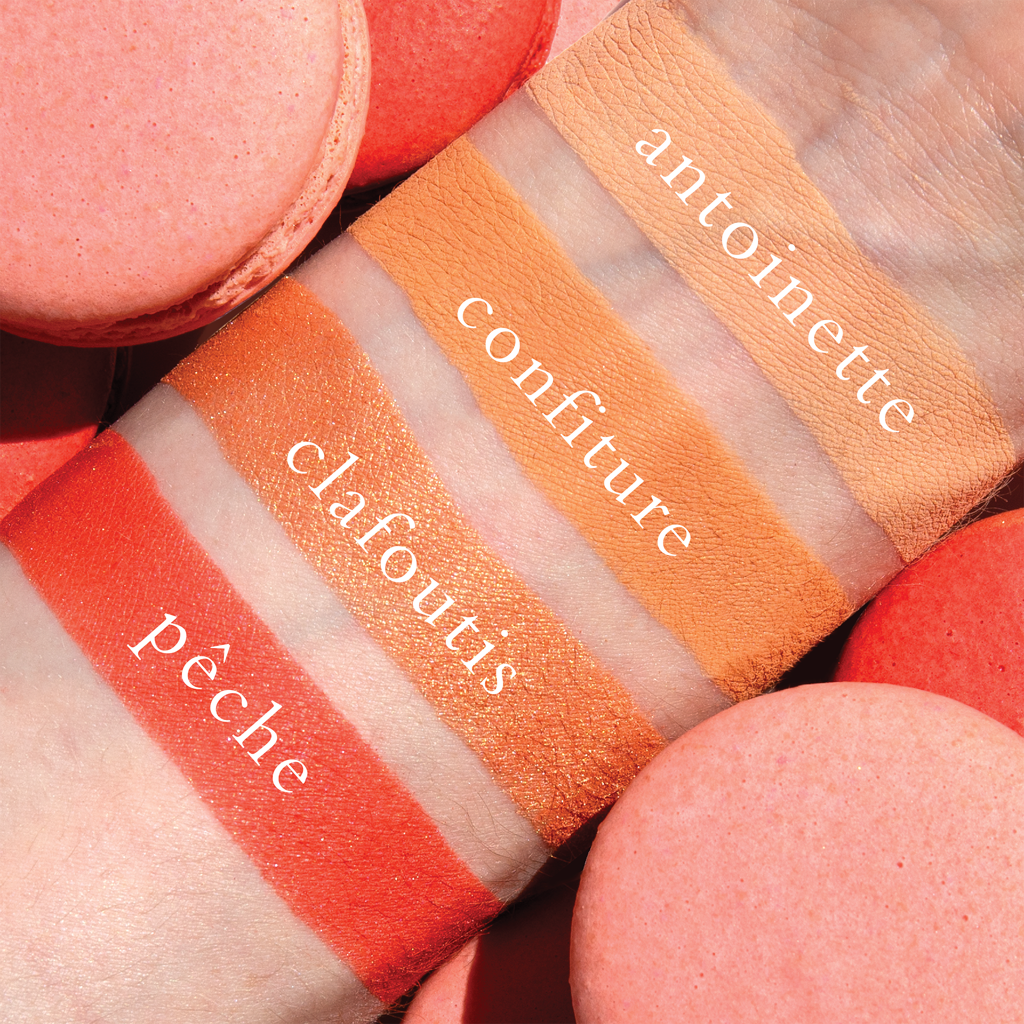 Swatches of golden peach, coral matte, and apricot shimmer from Petits Fours Pêche on fair skin tone.