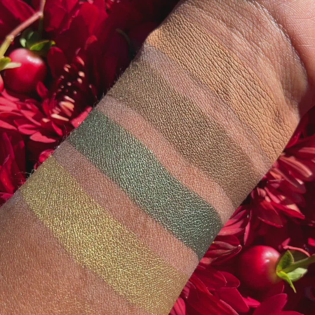 Video of Swatches of eyeshadow powders from the Petits Fours - Peridot palette on deep skin, showcasing elegant green and earthy brown tones to add a luxe look to any eye.